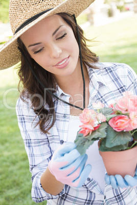 Young Adult Woman Wearing Hat Gardening Outdoors