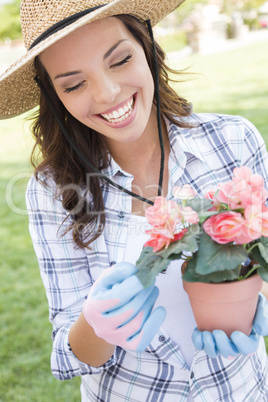 Young Adult Woman Wearing Hat Gardening Outdoors