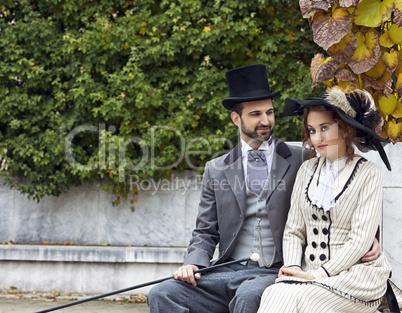 Old-fashioned dressed couple in the park