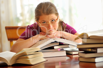teen girl learning at the desk, looking up teen girl learning at the desk, looking up