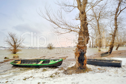 green boat on shore in winter