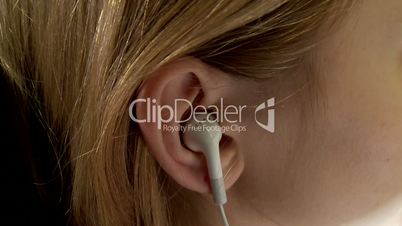 Ear with the earpiece (the Girl listens to music)