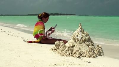 The girl on the beach with a Tablet PC