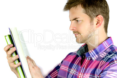 Thoughtful young man reading a book