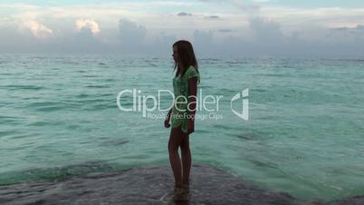 girl moisten his feet in the Caribbean Sea. Cuba, Cayo Largo