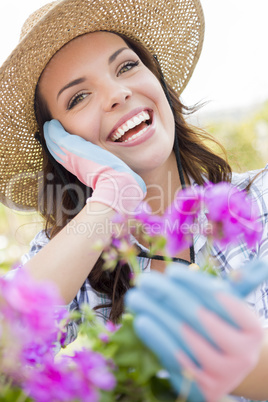 Young Adult Woman Wearing Hat Gardening Outdoors