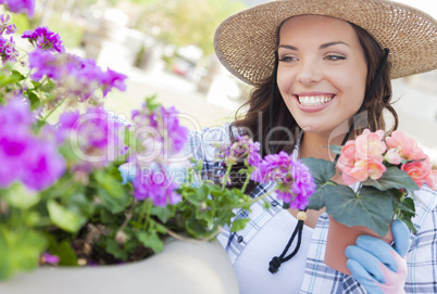 Young Adult Woman Wearing Hat Gardening Outdoors