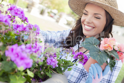 Young Adult Woman Wearing Hat Gardening Outdoors