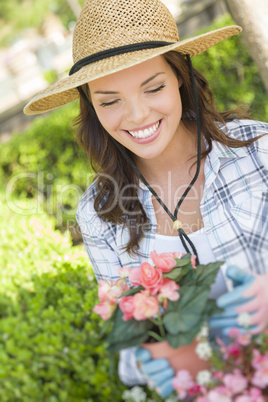 Young Adult Woman Wearing Hat Gardening Outdoors