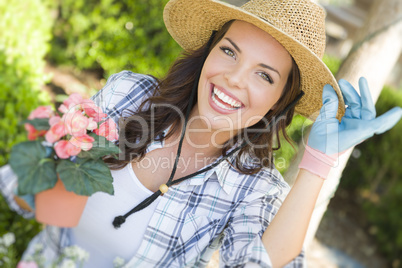 Young Adult Woman Wearing Hat Gardening Outdoors