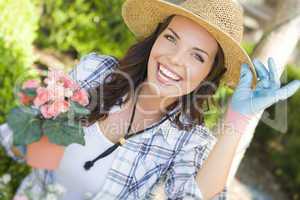 Young Adult Woman Wearing Hat Gardening Outdoors