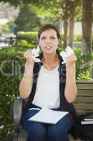 Upset Young Woman with Pencil and Crumpled Paper in Hands