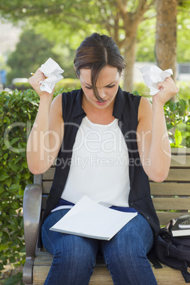 Upset Young Woman with Pencil and Crumpled Paper in Hands