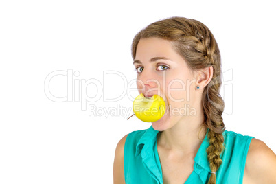 Girl taking a bite of an apple.