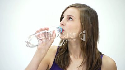 HD1080 Slim fitness girl drinking bottle of water. Portrait. Version 1