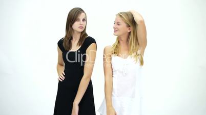 HD1080 Two young girls in white and black dress smiling and posing for the camera