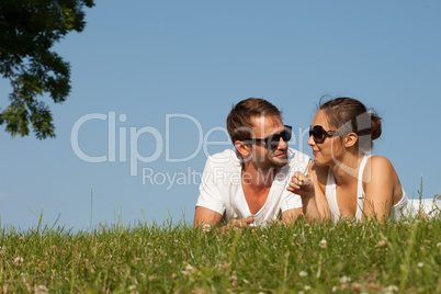 young couple lying on the grass