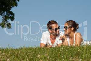 young couple lying on the grass