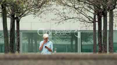 Female manager smoking cigarette near office building