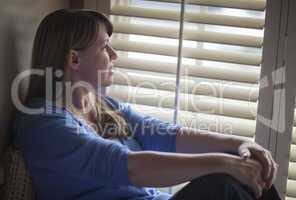Pensive Woman Sitting Near Window Shades