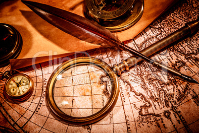 Vintage magnifying glass lies on an ancient world map