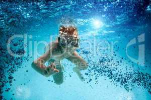 Teenager in the mask and snorkel swim underwater.