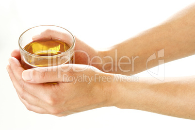Woman hands holding a glass of tea
