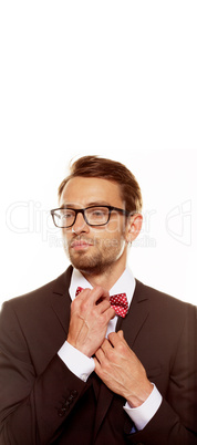 man straightening his bow tie