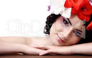 Beautiful young woman with flowers in their hair looks at the ca