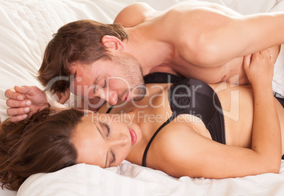young man and woman in bed. couple.