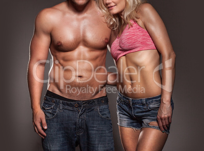 fitness image of a man and woman's torso isolated on black