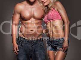 fitness image of a man and woman's torso isolated on black