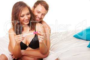 enamoured couple finding out results of a pregnancy test