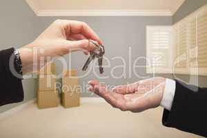 Woman Handing Over the House Keys Inside Empty Grey Room
