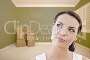 Young Woman Daydreaming in Empty Room with Boxes