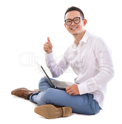 Thumb up Asian man using laptop