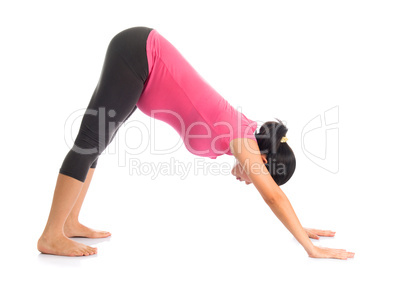 Asian pregnant yoga facing downward dog position.