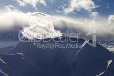 Mountains in evening and sunlight clouds