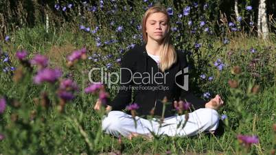 woman meditating in the city park