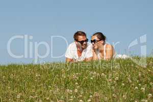 young couple lying on the grass