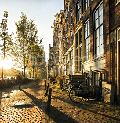 Wonderful and idyllic street scene at sunset in amsterdam.