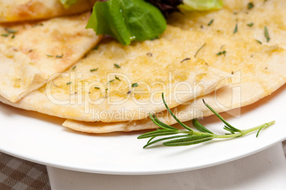 garlic pita bread pizza with salad on top