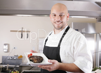 young male chef presenting a juicy ribeye steak with tomatoes
