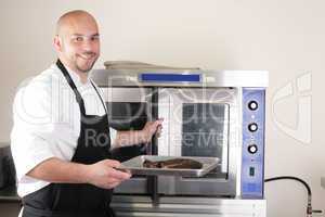 Happy chef taking his freshly baked rib-eye steak