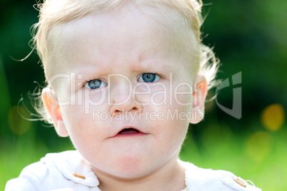 Baby girl portrait on the summer meadow