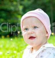 Baby with hat on the summer meadow