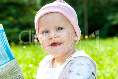 Baby with hat on the summer meadow