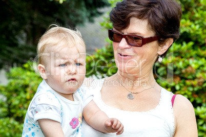 Happy mother holds daughter on the arm