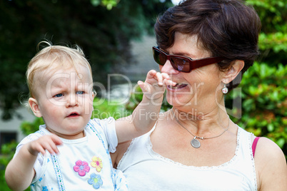 Happy mother holds daughter on the arm