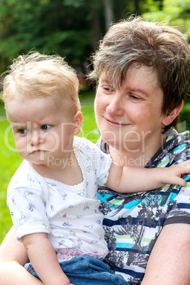 Happy mother holds daughter on the arm